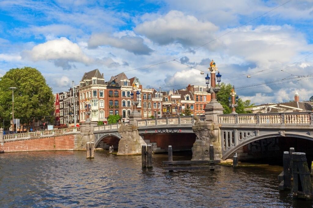  Blauwbrug bridge with stone lions and canal view in Amsterdam