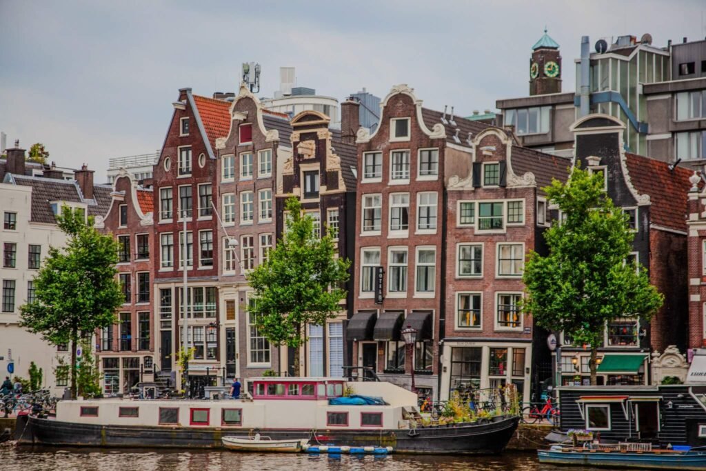  Crooked canal houses with gabled roofs in Amsterdam