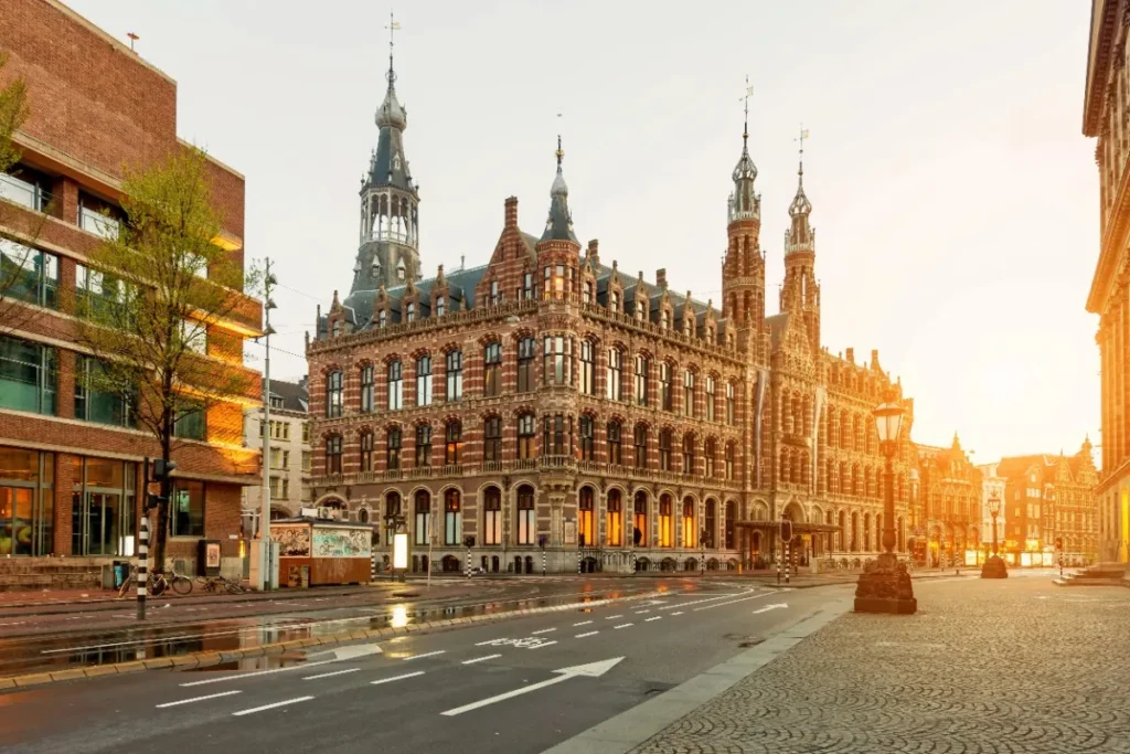 Dam Square in Amsterdam with the Royal Palace in the background Dam Square Amsterdam – Royal Palace and City Center View